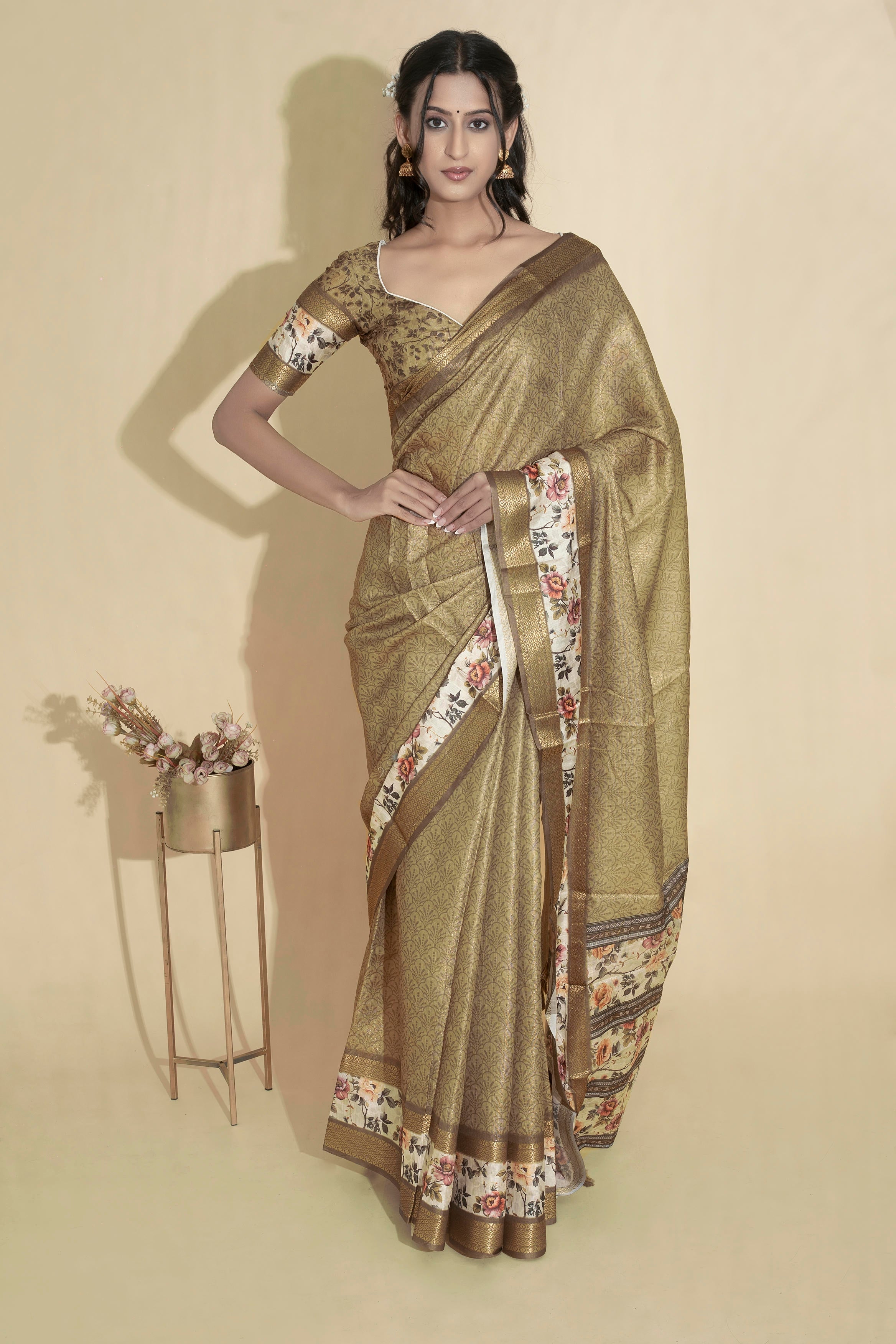 Antique gold olive textured saree with floral border, zari detailing and tassel pallu