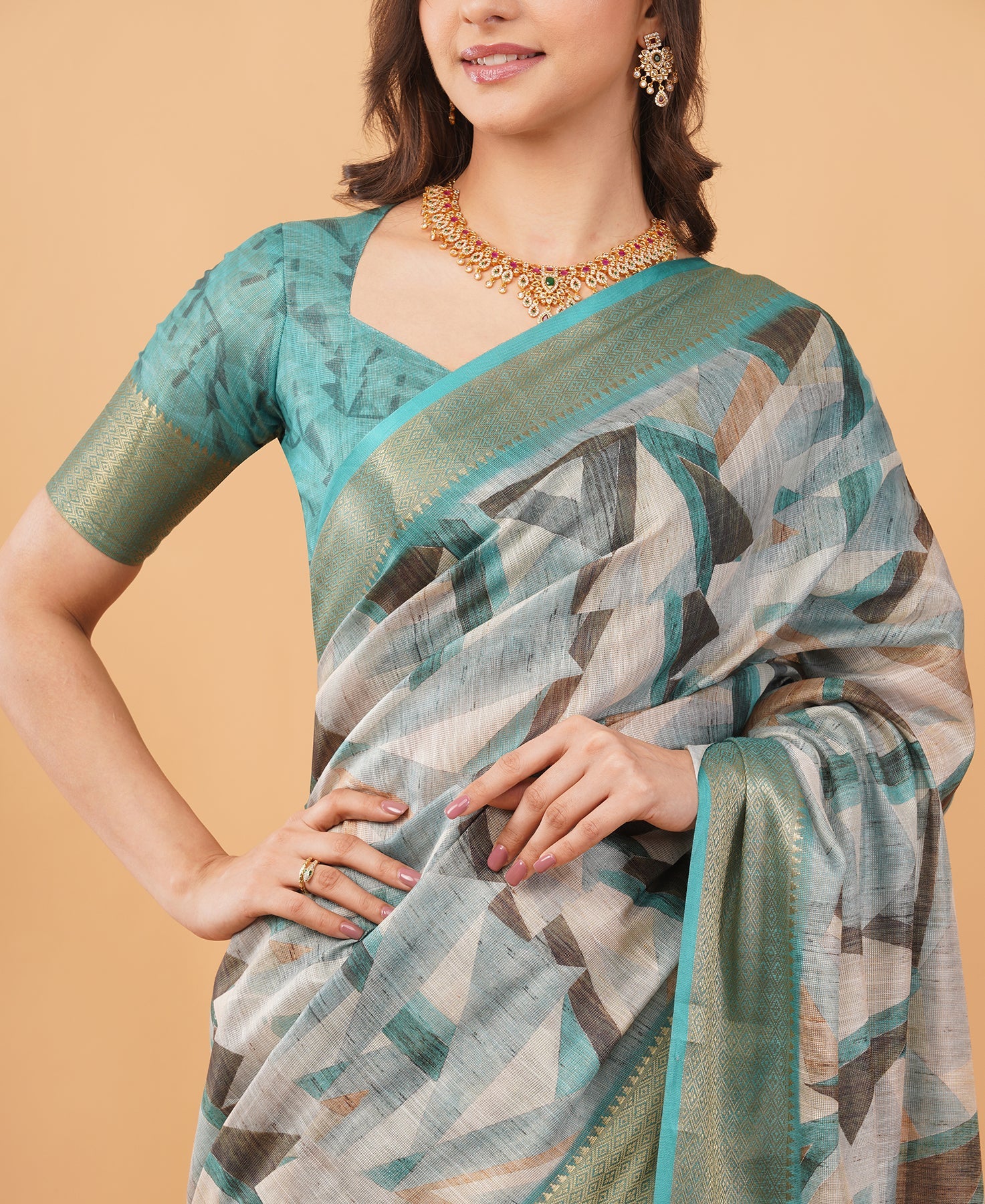 Teal and grey geometric print saree with dull gold zari border and ruched sweetheart blouse