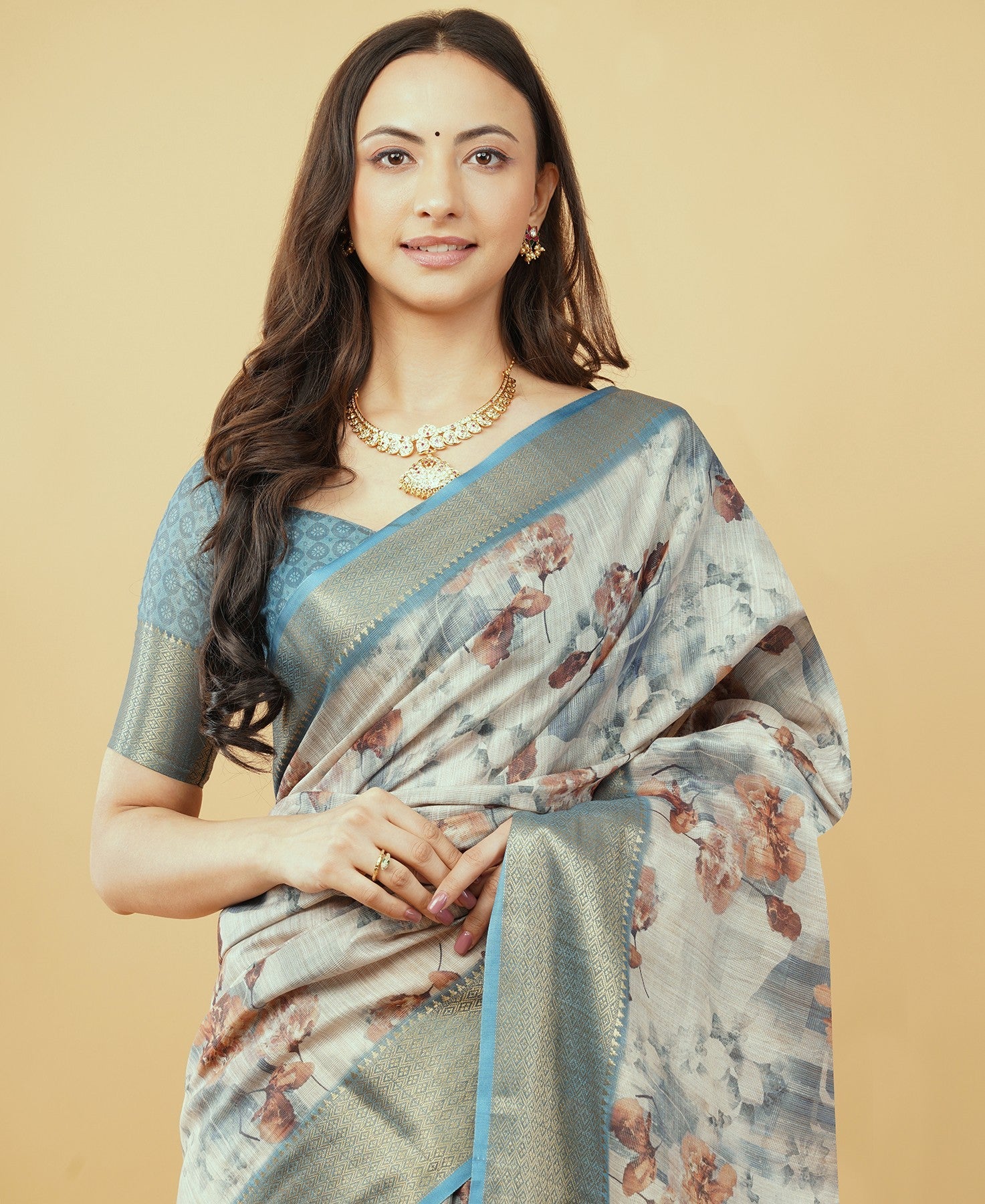Dusty blue and beige abstract floral saree with antique gold zari border and tassel pallu