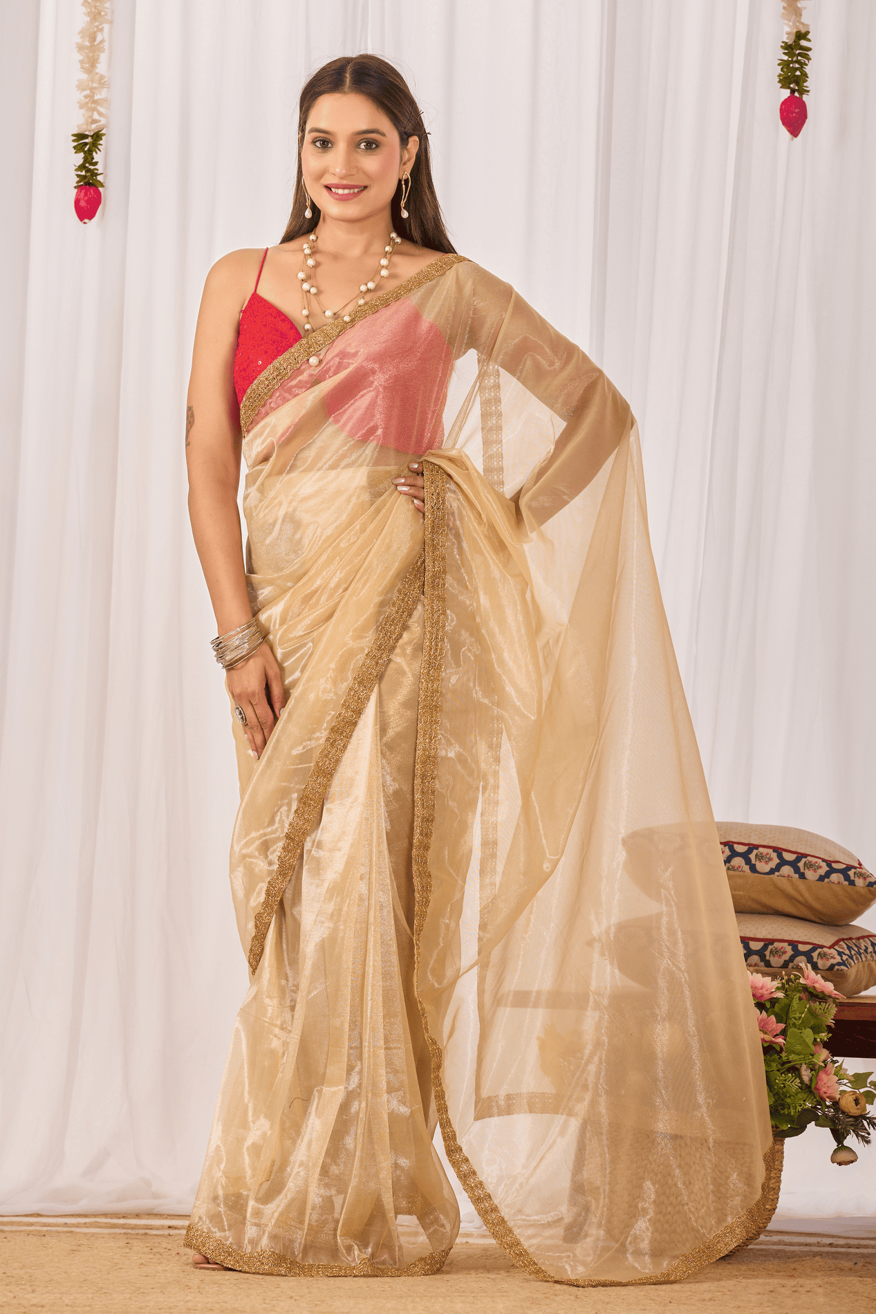 Champagne gold ready-to-wear shimmer saree with sequin border and red sleeveless strappy blouse