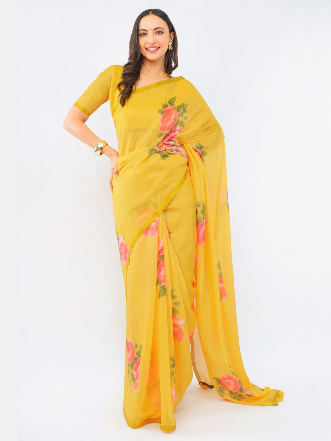 Dark yellow linen saree with vibrant rose floral prints and gold zari border draped by woman for summer festive wear by Samantha