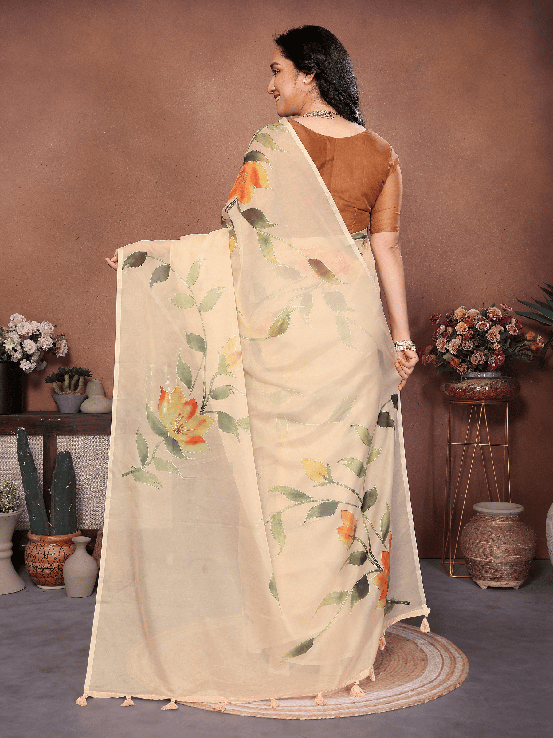 Cream Floral Print Saree with Orange Lily Motifs and Ruched Bronze Blouse