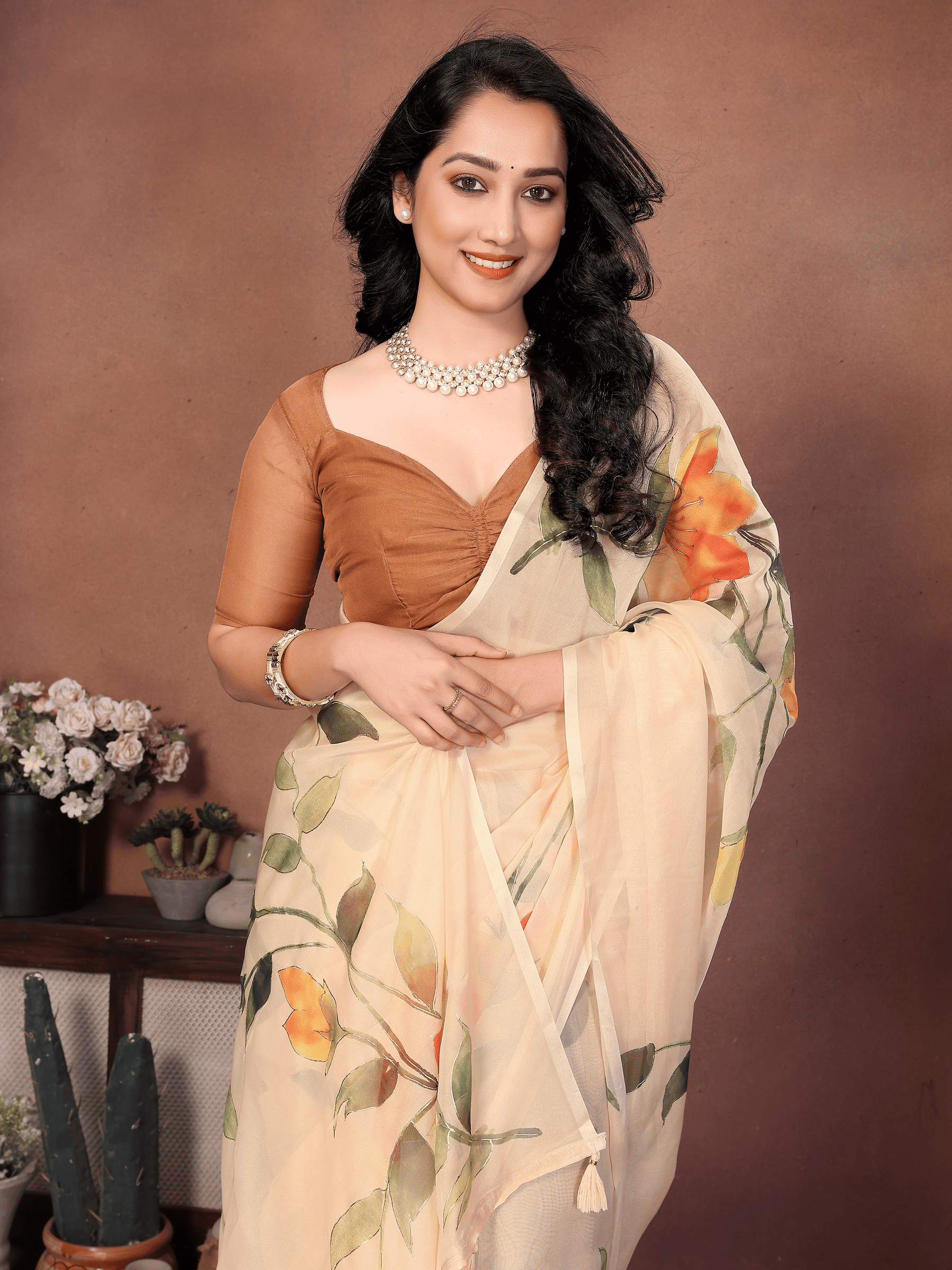 Cream Floral Print Saree with Orange Lily Motifs and Ruched Bronze Blouse