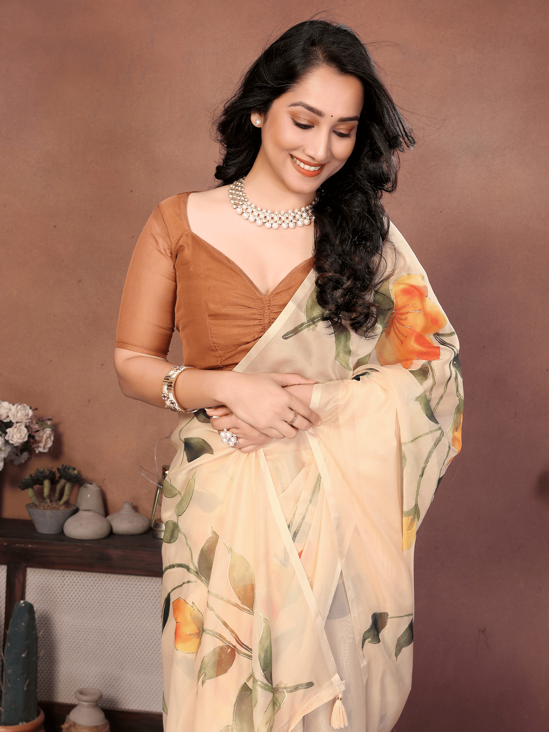 Cream Floral Print Saree with Orange Lily Motifs and Ruched Bronze Blouse